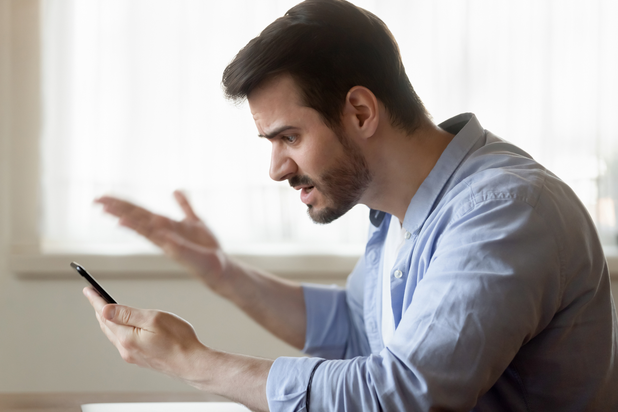 Man Frustrated with Cell Phone